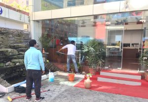Professional team performing commercial building cleaning in a Kathmandu office space.