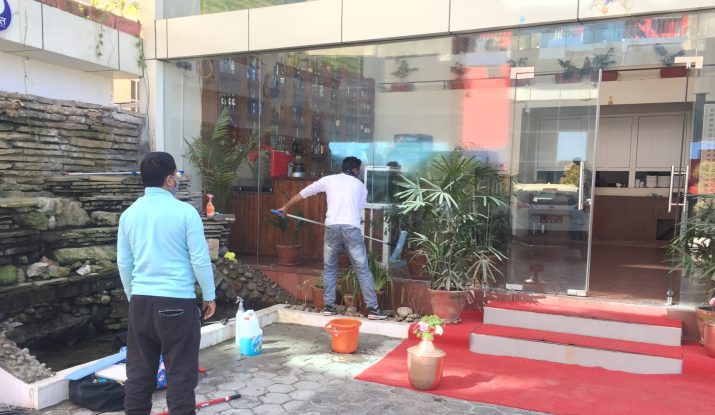 Professional team performing commercial building cleaning in a Kathmandu office space.